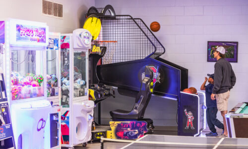 2 young boys playing a game in the game room