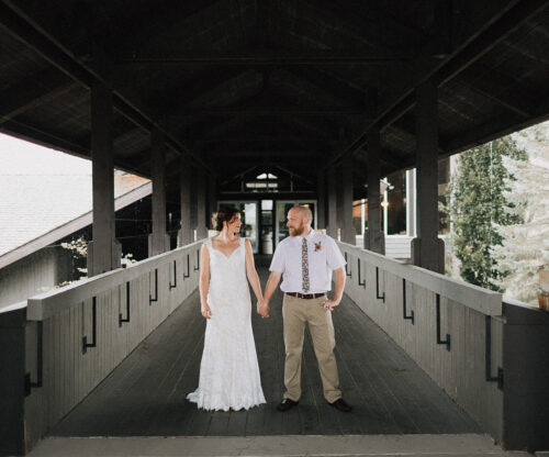 Bride and groom on wooden bridge