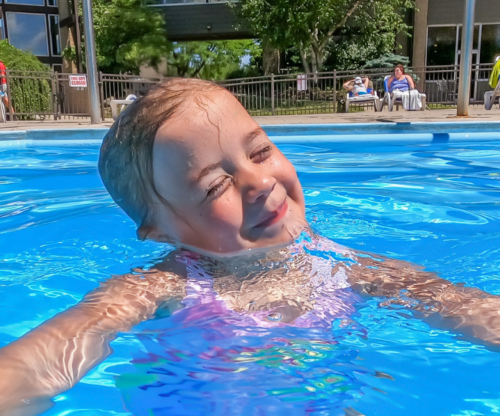 Kid smiling and swimming