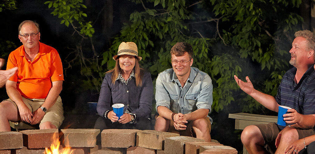 Family taking around a firepit